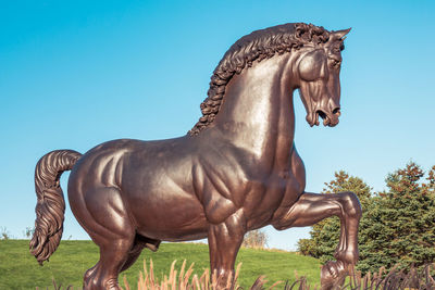 View of horse statue against clear blue sky