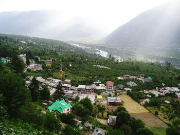 High angle view of townscape and houses against mountains