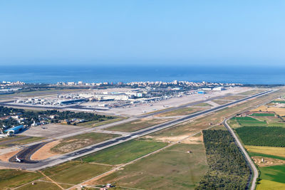 High angle view of city by sea against sky