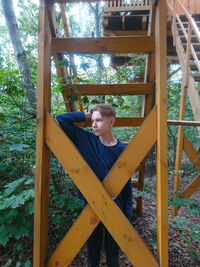 Young man sitting in playground