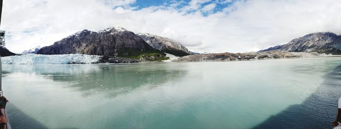 Panoramic view of sea and mountains against sky