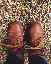 Low section of man standing by shoes