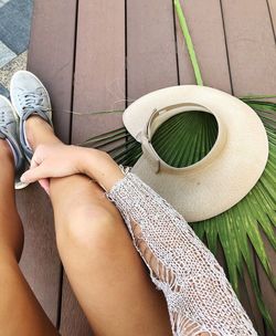 Low section of woman sitting on wooden floor