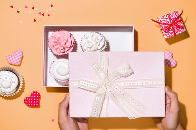 Directly above shot of hand holding paper in box