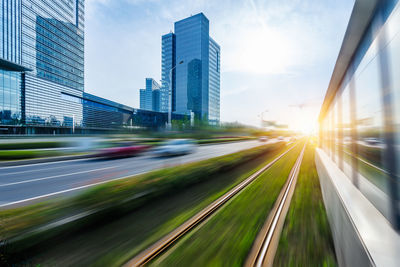 Blurred motion of car on road against sky