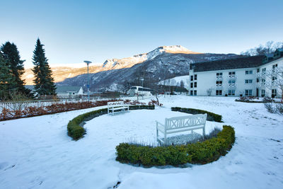 Snow covered buildings against sky