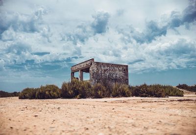 House on beach against sky