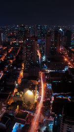 High angle view of illuminated buildings in city at night