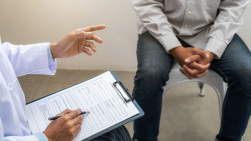 Midsection of couple holding hands