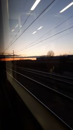 Railroad tracks against sky during sunset