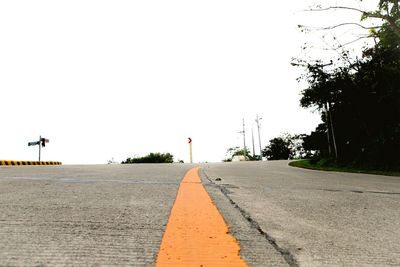 Surface level of road against clear sky