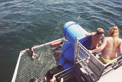 High angle view of people sitting on boat in sea