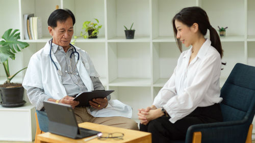 Side view of doctor using laptop at home