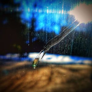 Close-up of wet leaf against sky