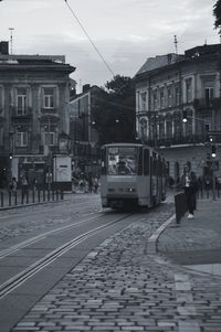 View of railroad tracks by buildings in city