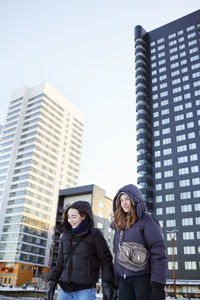 Smiling young women in modern neighborhood