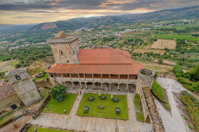 High angle view of buildings against cloudy sky