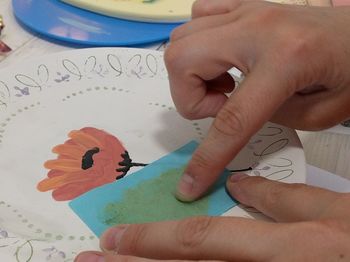 Close-up of baby hand holding paper