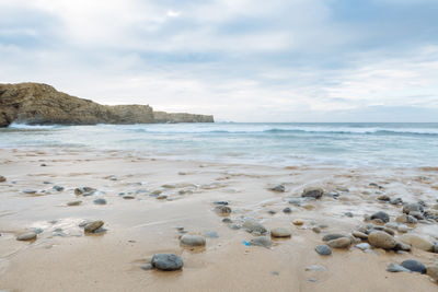 Scenic view of sea against cloudy sky