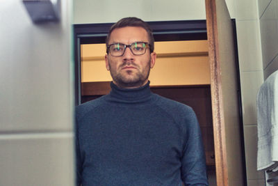 Portrait of young man at home