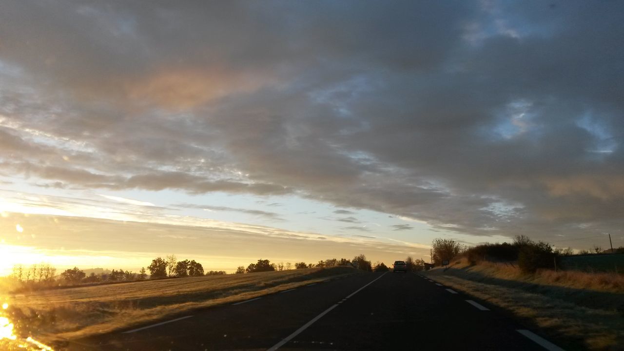 transportation, the way forward, road, sky, diminishing perspective, vanishing point, cloud - sky, sunset, country road, road marking, landscape, cloudy, tranquility, nature, tranquil scene, car, tree, scenics, cloud, street