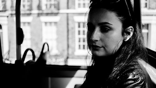 Close-up of thoughtful woman traveling in bus