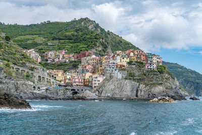 Scenic view of sea and buildings against sky