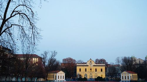 Low angle view of buildings against clear blue sky