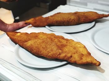 Close-up of fritters served in plates on table at restaurant