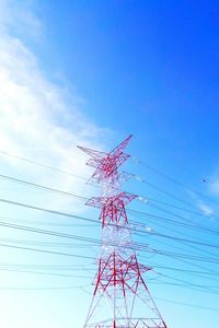 Low angle view of power lines against blue sky