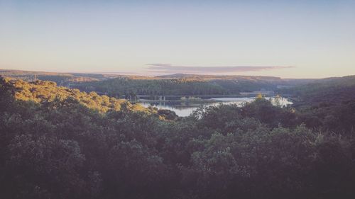 Scenic view of river and mountains against clear sky