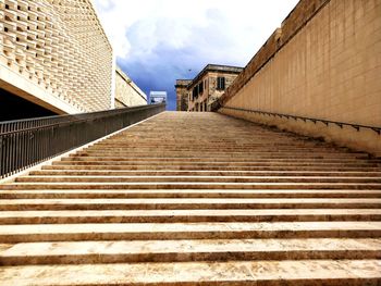 Low angle view of staircase by building against sky