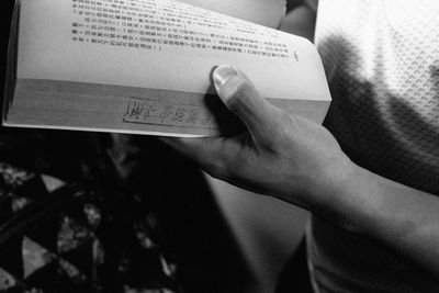 Close-up of hand holding book