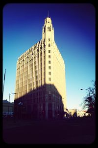 Low angle view of buildings against blue sky