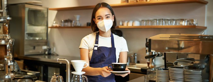 Portrait of young woman working in cafe