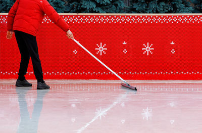 Low section of man playing with snow