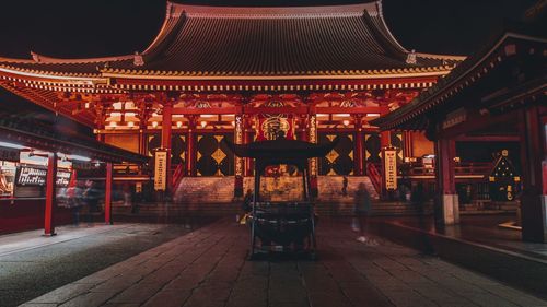 Interior of illuminated temple building in city