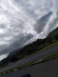 View of street against cloudy sky