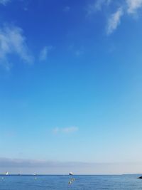 Scenic view of sea against blue sky