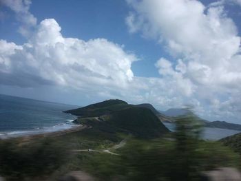 Scenic view of sea and mountains against sky