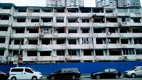 Cars on road by buildings in city