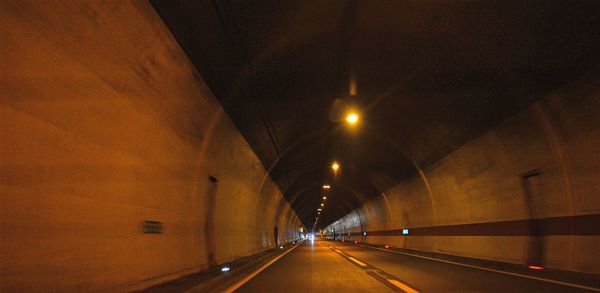 Illuminated tunnel at night