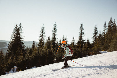 Man skiing on mountain road during winter