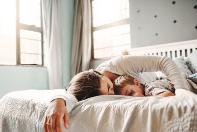 Young woman sleeping on bed at home