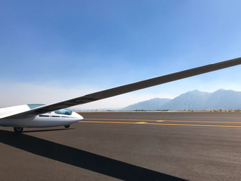 Airplane on runway against sky