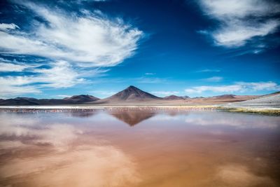 Scenic view of lake and mountains against sky