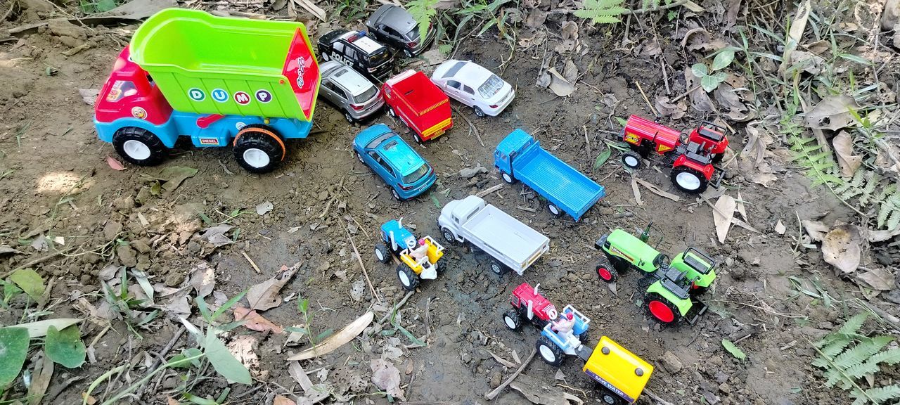 high angle view, vehicle, transportation, day, litter, mode of transportation, car, no people, toy, land vehicle, soil, wheel, outdoors, nature, toy car, land, motor vehicle