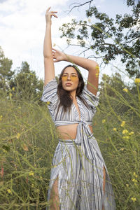 Powerful stylish latina woman in flower fields