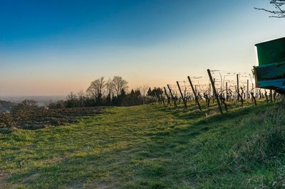 Scenic view of landscape against clear sky at dusk