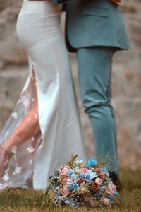 Low section of woman standing on field